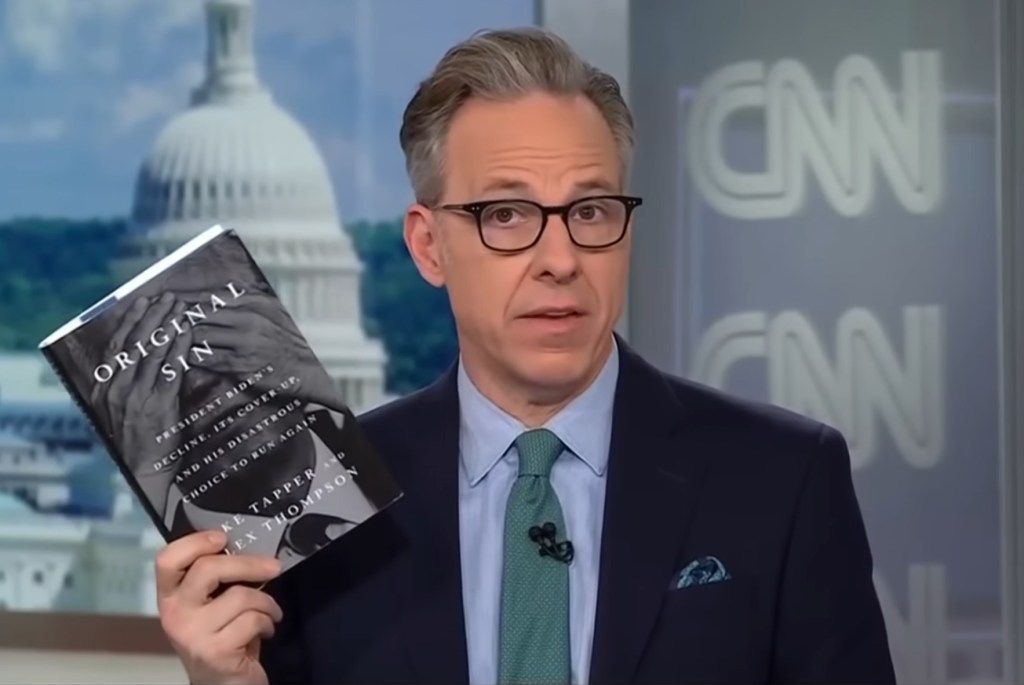 Tapper holding his book "Original sin"